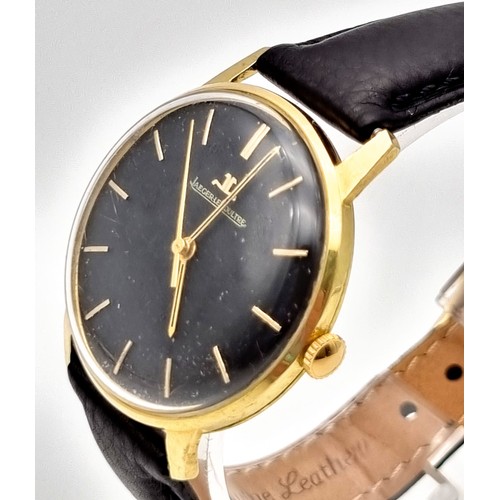 692 - A Vintage Jaeger Le Coultre 18K Gold Gents Watch. Black leather strap. Gold case - 35mm. Black dial ... 