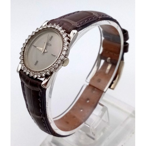 621 - A Jaeger Diamond Bezel Ladies Watch. Leather strap. Diamond bezel case - 23mm. Quartz movement.