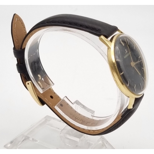 692 - A Vintage Jaeger Le Coultre 18K Gold Gents Watch. Black leather strap. Gold case - 35mm. Black dial ... 