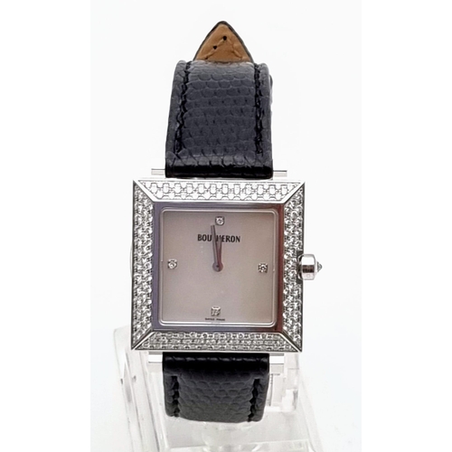 81 - A Boucheron 18K Gold and Diamond Ladies Watch. Black leather strap. Gold and diamond rectangular cas... 