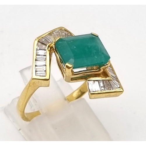 88 - An 18K Yellow Gold Emerald and Diamond Ring. Central cut natural emerald with 26 tapered baguette cu... 