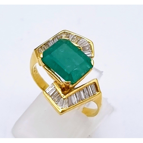 88 - An 18K Yellow Gold Emerald and Diamond Ring. Central cut natural emerald with 26 tapered baguette cu... 