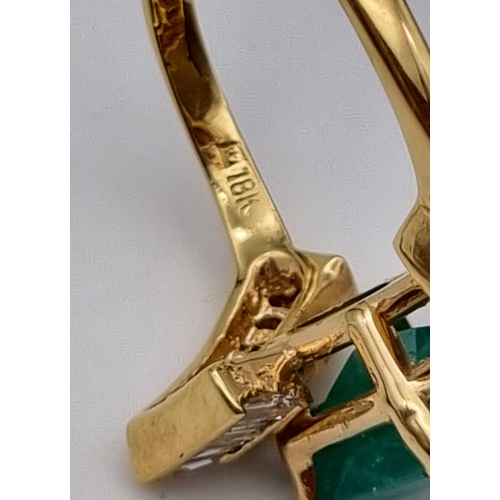 88 - An 18K Yellow Gold Emerald and Diamond Ring. Central cut natural emerald with 26 tapered baguette cu... 