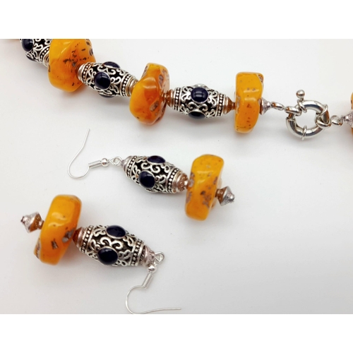 126 - A butterscotch amber and lapis lazuli, Tibetan silver, chunky necklace and earrings set. Necklace le... 