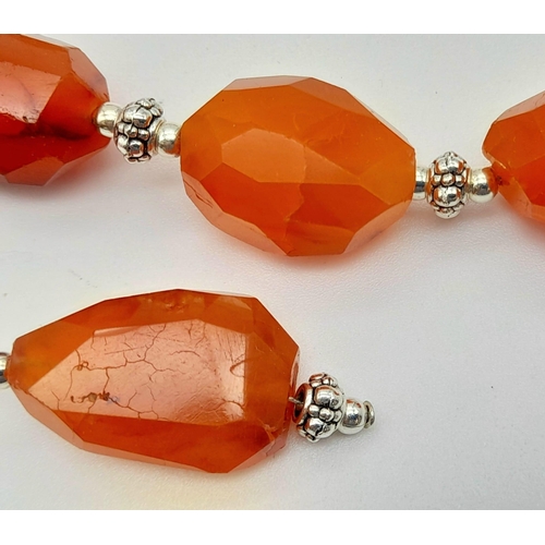 175 - A vintage, Tibetan silver, large faceted carnelian beaded necklace, bracelet and earrings set. Neckl... 