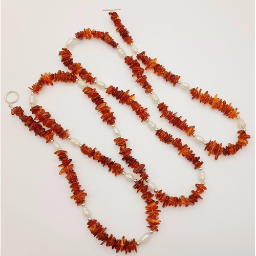 196 - A natural Baltic amber (cognac coloured) and Scottish fresh water pearls, opera length necklace.
Len... 