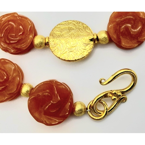 218 - A very unusual, hand carved, rose forming, carnelian beads and yellow gold gilded necklace and earri... 