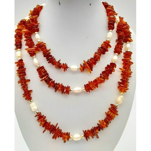 196 - A natural Baltic amber (cognac coloured) and Scottish fresh water pearls, opera length necklace.
Len... 