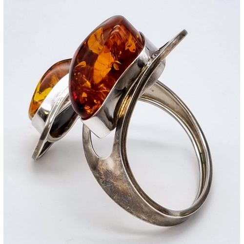 36 - A Baltic Amber Spiral Bangle Bracelet. Two irregular shaped pieces of amber add mystique to this ecl... 