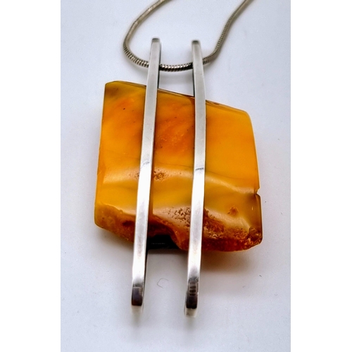 85 - A Honey Amber Pendant Chunk on a 925 Silver Necklace.
Amber 3 x 4.5cm. Necklace - 48cm.