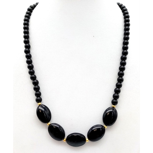 443 - A Black Oval and Small Bead Agate Necklace. 42cm