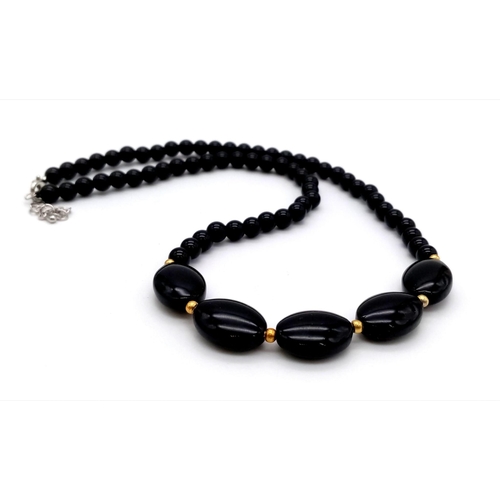 443 - A Black Oval and Small Bead Agate Necklace. 42cm