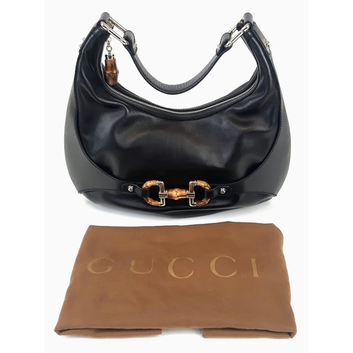 92 - A Gucci Amalfi Full Black Leather Bamboo Handbag. Gold tone hardware. Bamboo clasp and handle. Cloth... 