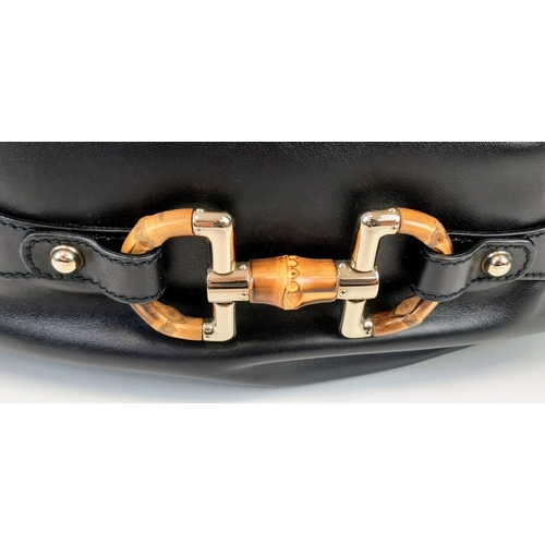 92 - A Gucci Amalfi Full Black Leather Bamboo Handbag. Gold tone hardware. Bamboo clasp and handle. Cloth... 