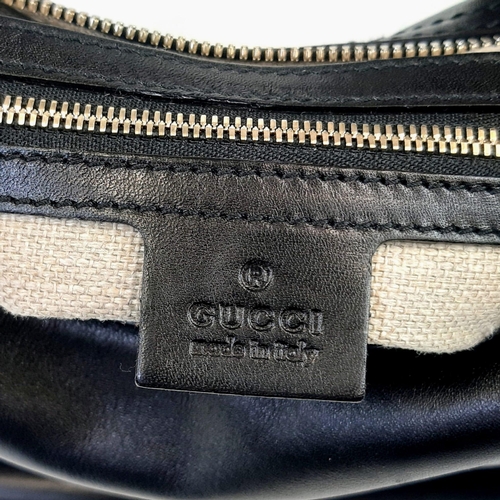 92 - A Gucci Amalfi Full Black Leather Bamboo Handbag. Gold tone hardware. Bamboo clasp and handle. Cloth... 