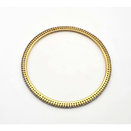 281 - A 18K GOLD AND DIAMOND SLAVE BANGLE, 12.7gms   7cms diameter