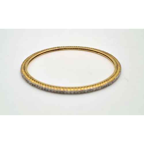 281 - A 18K GOLD AND DIAMOND SLAVE BANGLE, 12.7gms   7cms diameter