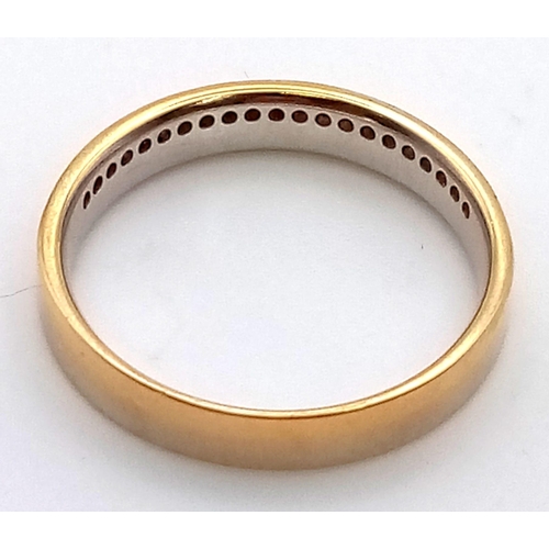 288 - AN 18K GOLD BAND RING WITH CHANNEL SET DIAMONDS.  3.1gms  size N