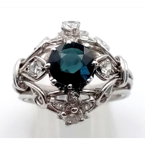 138 - A PLATINUM DIAMOND AND SAPPHIRE CLUSTER RING.  10.4gms  size N