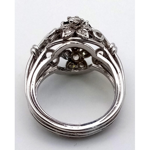 138 - A PLATINUM DIAMOND AND SAPPHIRE CLUSTER RING.  10.4gms  size N