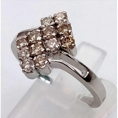 267 - A 14K WHITE GOLD CROSS OVER 12 STONE RING.  4gms  size P