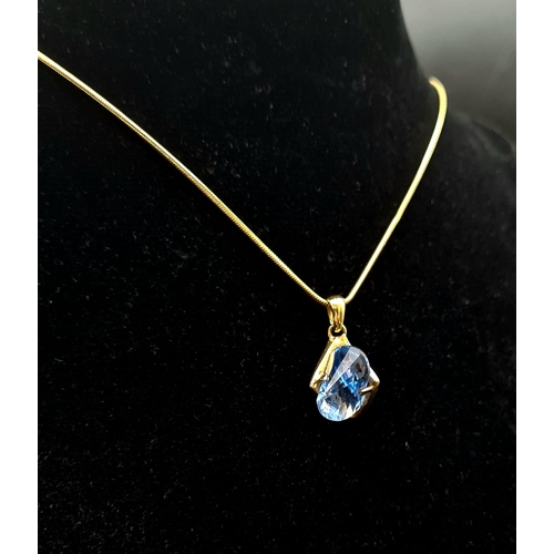 44 - A Breath-Taking 18K Yellow Gold Blue Topaz Pendant on an 18K Gold Snake-Link Necklace. Topaz - 5ct. ... 