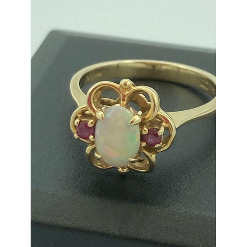 77 - 9 carat GOLD RING  ring having OPAL and PINK TOPAZ set to top in GOLD openwork mount.
 3.3 grams. Si... 