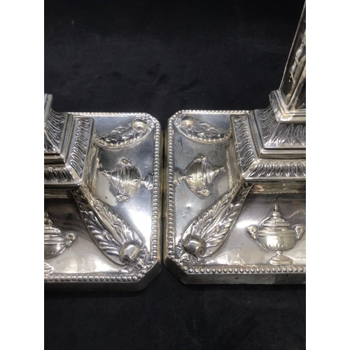 134 - A pair of early George V sterling solid silver mounted candlesticks, each with filled square base ha... 