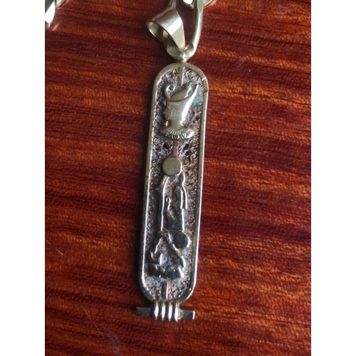 477 - 18 Ct 750 Italy stamped solid thick kerb link chain, Together with A pendant with EGYPTION HIEROGLYP... 