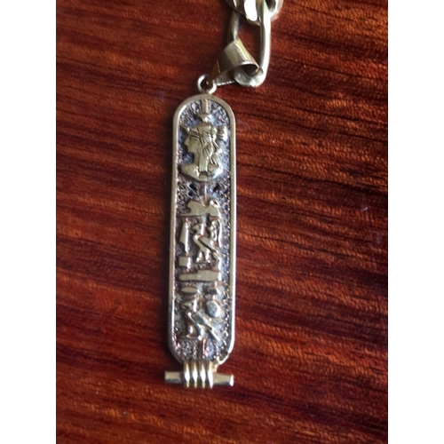 477 - 18 Ct 750 Italy stamped solid thick kerb link chain, Together with A pendant with EGYPTION HIEROGLYP... 