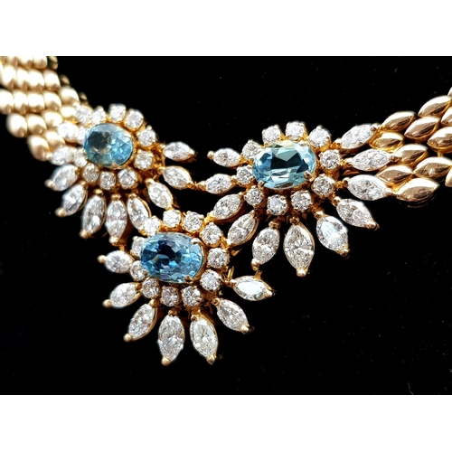 128 - A  STUNNING 18K GOLD NECKLACE WITH AQUAMARINE AND DIAMONDS FORMiNG A FLORAL DESIGN . 20.5 gms  with ... 