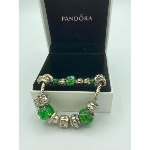 287 - PANDORA SILVER BRACELET Full of charms to include Silver and green marble glass. 19cm.