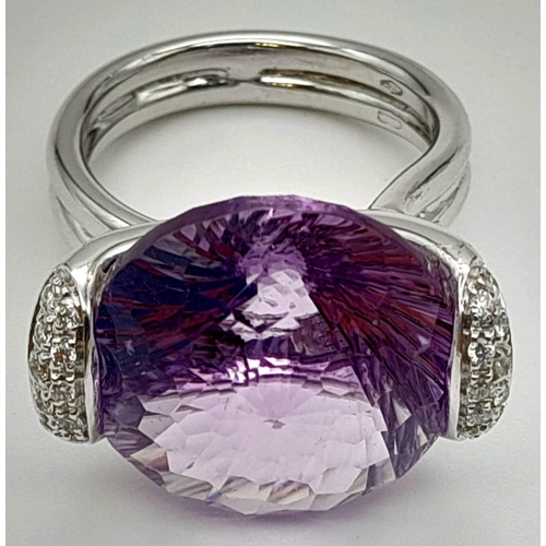 115 - An impressive 18 K white gold cocktail ring with large central amethyst and diamonds on the shoulder... 