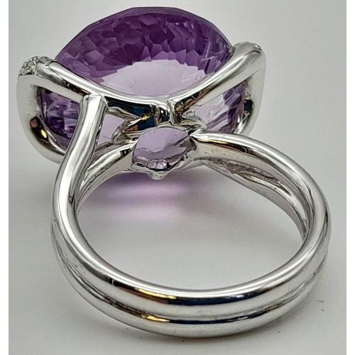 115 - An impressive 18 K white gold cocktail ring with large central amethyst and diamonds on the shoulder... 