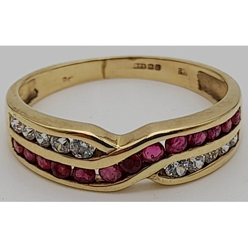 219 - A 9 K  yellow gold ring with rubies and diamonds in a cross over design. Size: n, weight: 1.9 g.