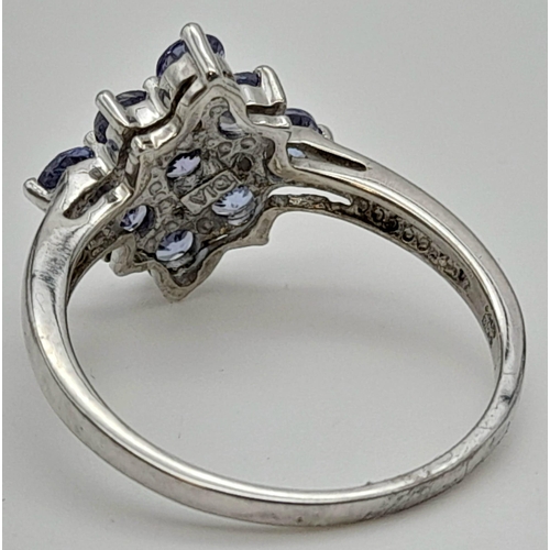 299 - A 9 K white gold ring with iolite and diamonds. Size: P, weight: 3 g.