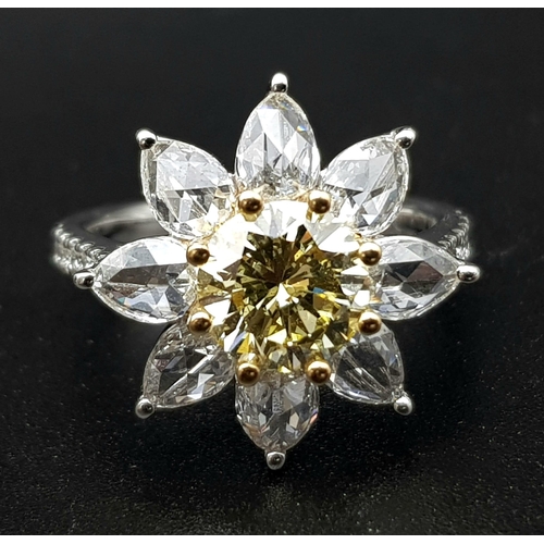 67 - A STUNNING PLATINUM RINGWITH A FANCY YELLOW DIAMOND AT THE CENTRE OF A FLORAL DESIGN SURROUNDED BY W... 