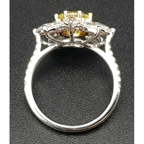 67 - A STUNNING PLATINUM RINGWITH A FANCY YELLOW DIAMOND AT THE CENTRE OF A FLORAL DESIGN SURROUNDED BY W... 