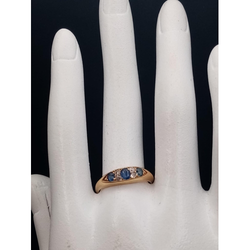 247 - An 18ct yellow gold slim band with three sapphires alternate between double set diamonds,  ring size... 