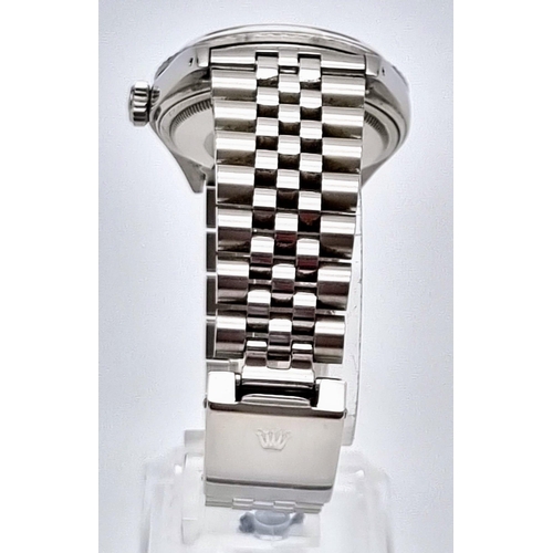 59 - A Rolex Oyster Perpetual Datejust Gents Watch. Stainless steel strap and case - 36mm. Silver tone di... 