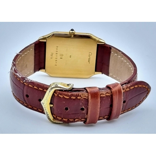 87 - A Cartier Santos 18K Gold Cased Ladies Quartz Tank Watch. Brown leather strap. Case - 35 x 27mm. In ... 