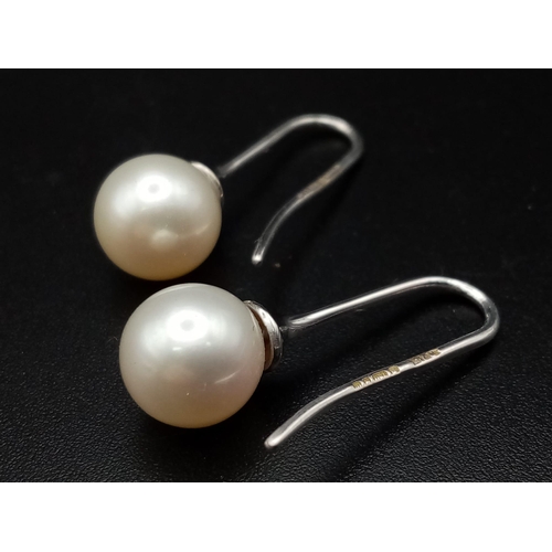 9 - 7mm Pearl drop earrings on 18 carat white gold fish hooks very unique and totally classic in design,... 