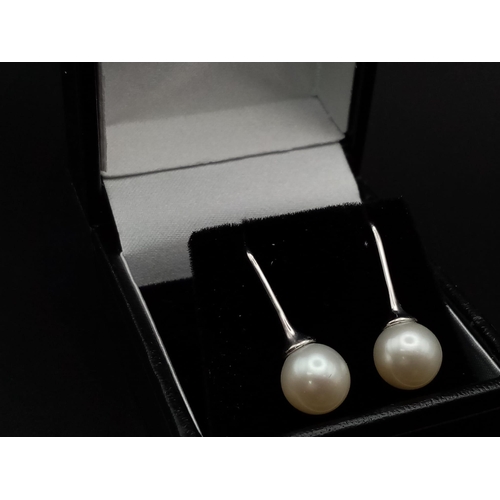 9 - 7mm Pearl drop earrings on 18 carat white gold fish hooks very unique and totally classic in design,... 