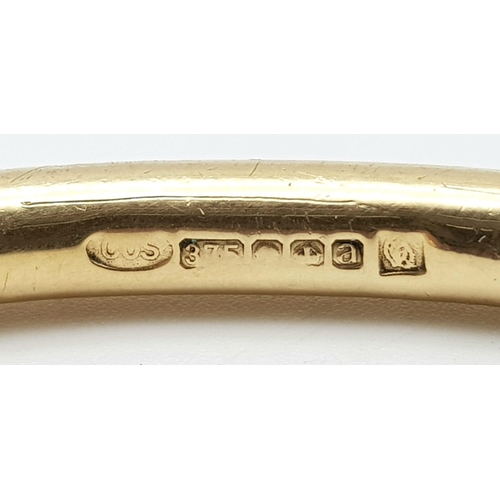 240 - A 9 K yellow gold solid torque bangle. Weight: 33.5 g.