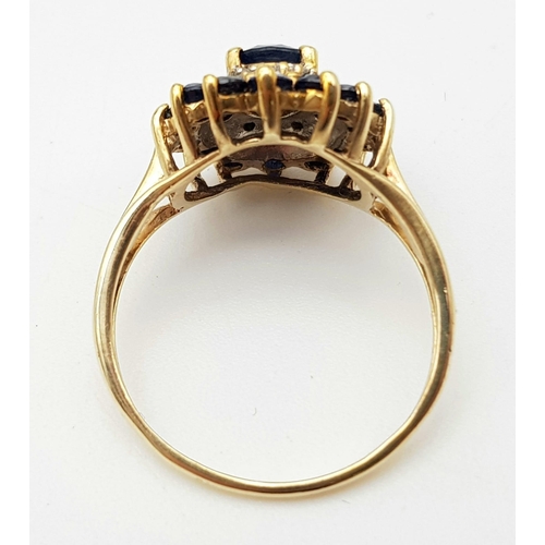 95 - A 9 K yellow gold ring with a diamond and sapphire cluster. Ring size: Q, weight: 3.2 g.