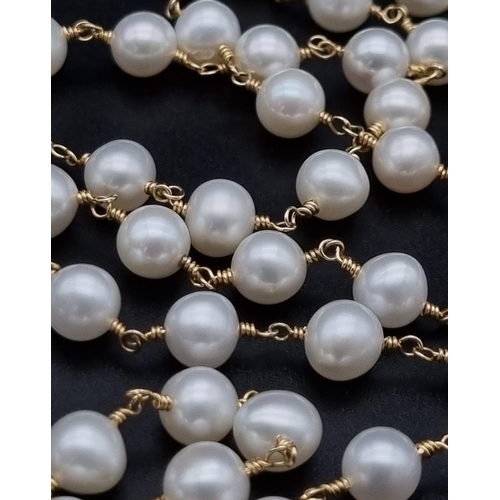 275 - A wire wrapped row of 32 inches cultured pearls.