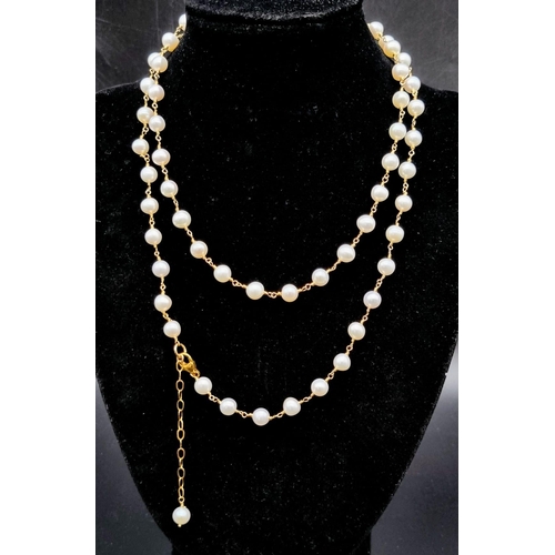 275 - A wire wrapped row of 32 inches cultured pearls.