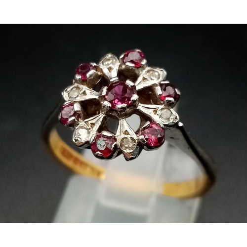 603 - An 18 K white & yellow gold ring with a cluster of rubies and diamonds.