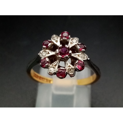 603 - An 18 K white & yellow gold ring with a cluster of rubies and diamonds.