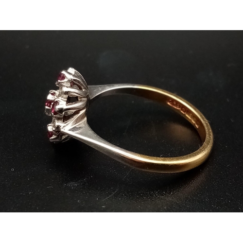 603 - An 18 K white & yellow gold ring with a cluster of rubies and diamonds.